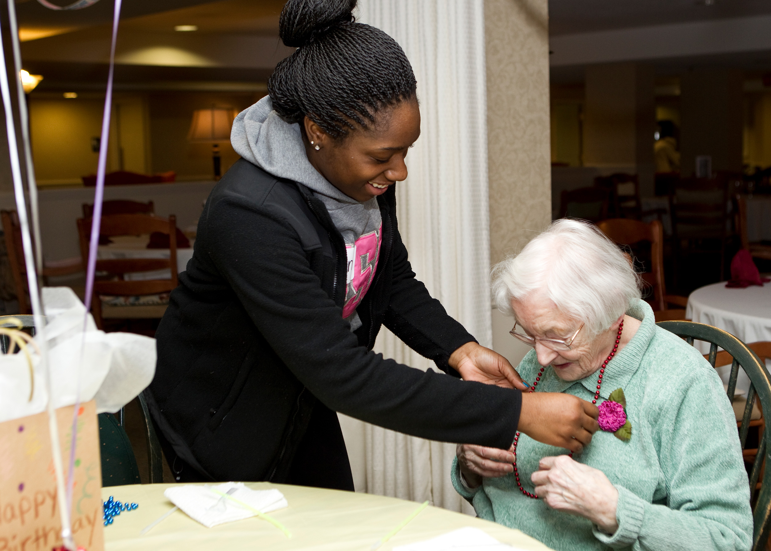 Student helping a retiree